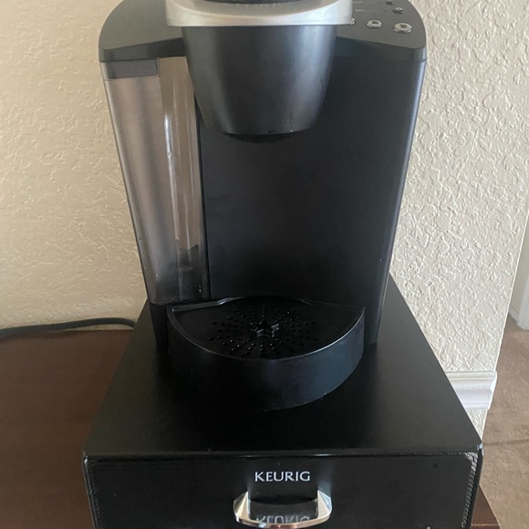 A keurig coffee making with pod storage.